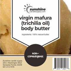 Close-up of golden mafura butter in a sleek glass jar, showcasing its rich, velvety texture against minimalist packaging.