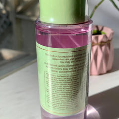 Toner bottle with pink liquid, green cap, and white label with text for daily use.