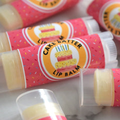 Lip balm tubes with pink confetti pattern, "Cake Batter" label, and clear plastic casing