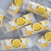Lip balm tubes with yellow and white labels, clear plastic, and visible "Lemon Drop Lip Balm" text