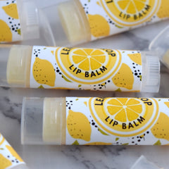 Lip balm tubes with yellow lemon pattern and "Lip Balm" text on white label