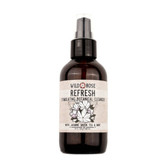 Botanical cleanser bottle, brown glass, label with Wild Rose text and floral design, pump top