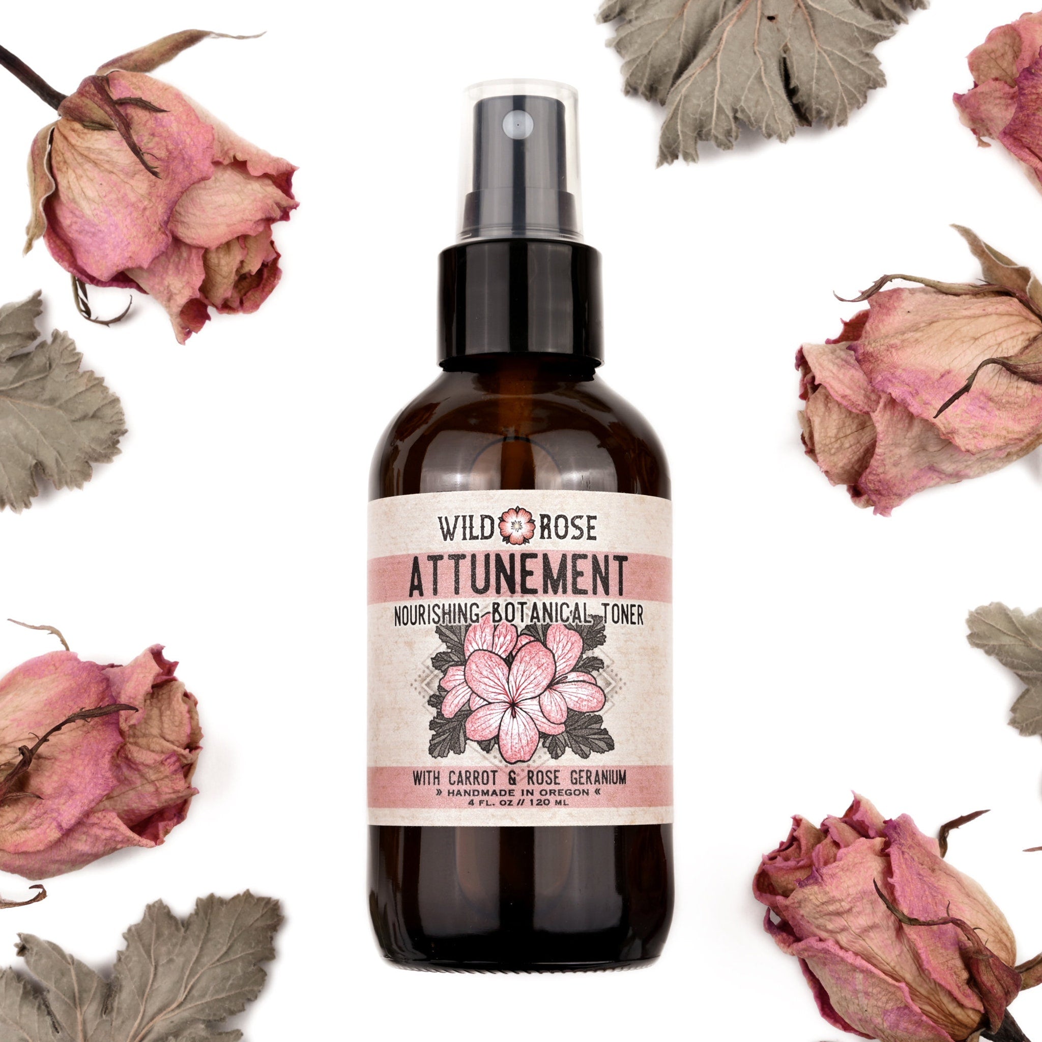 Toner bottle with brown glass, white label, and dried pink flowers around it