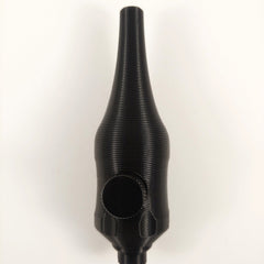 Close-up of handpoke skincare tool gently pressed against cheek during treatment