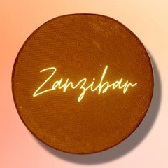 Side view of vegan ZANZIBAR pressed eyeshadow pan showcasing its smooth matte texture and compact size