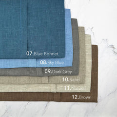 Linen fabric swatches in blue, grey, and brown colors, with visible texture and color names