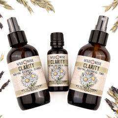 Botanical skincare products in brown glass bottles with floral labels, Wild Rose Clarity brand