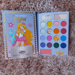 Luxi Beauty Tangle Love Eyeshadow Palette with 12 vibrant matte and shimmer shades in a sleek black compact