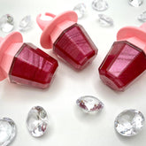 Lip gloss raspberry color with pink ring-shaped applicator and clear container