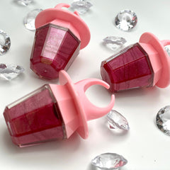 Pink ring pop lip gloss with red shimmer and clear plastic diamonds scattered around