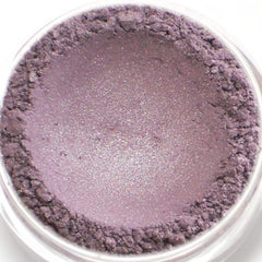 Eyeshadow powder in purple with shimmer, in a clear container