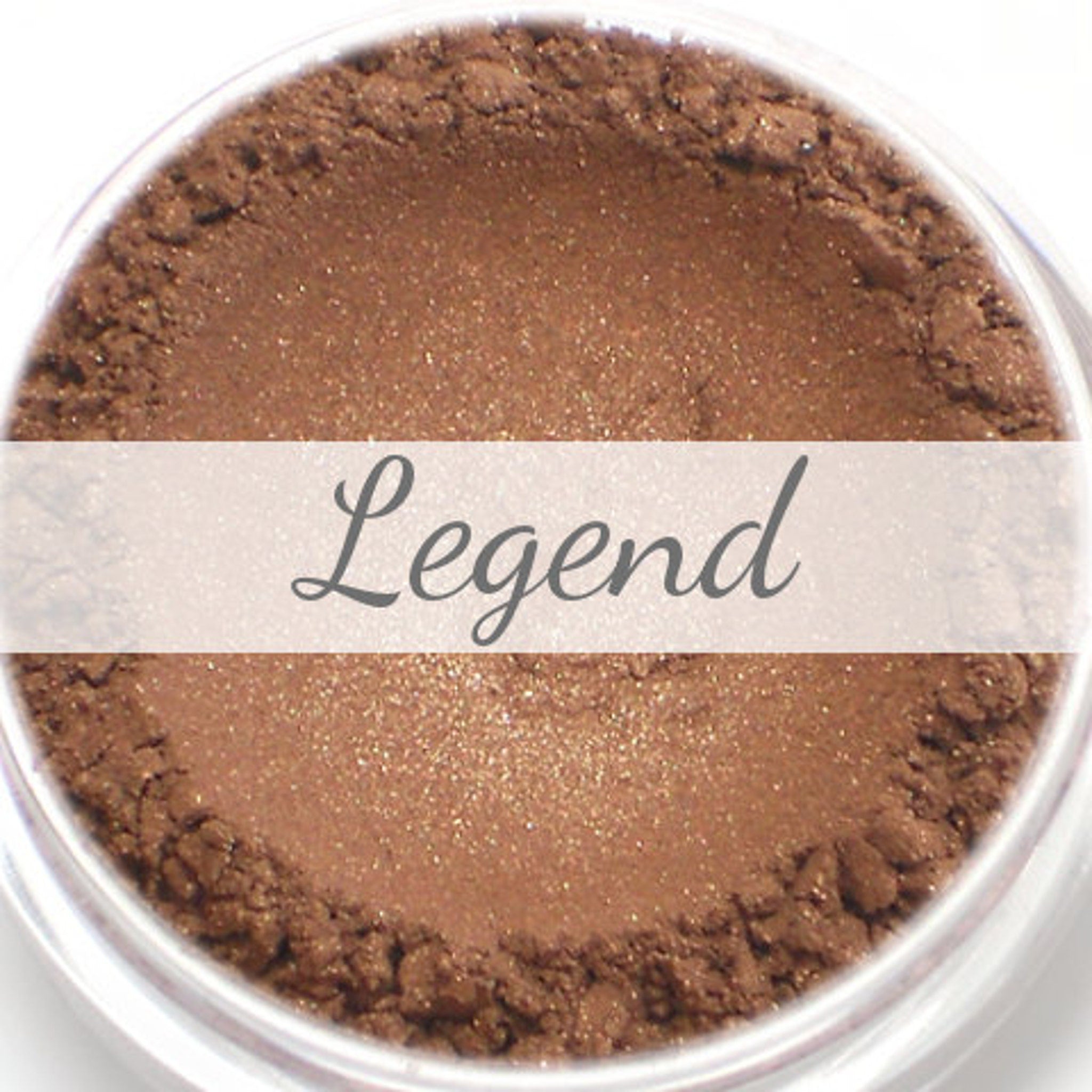 Close-up of Legend Bronze Brown mineral eyeshadow sample in compact with shimmering warm bronze-brown tones