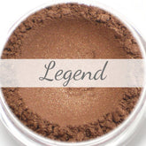 Close-up of Legend Bronze Brown mineral eyeshadow sample in compact with shimmering warm bronze-brown tones