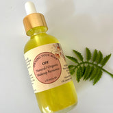 Makeup remover bottle with yellow liquid, gold cap, and OFF label on white surface