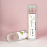Lip balm tubes with red tint, clear plastic, and Wild Jasmine branding on white labels