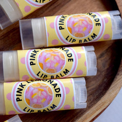 Lip balm tubes with yellow polka dot labels, clear plastic, and pink lemonade text