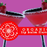 Lip balm flavor oil, red cocktail glasses with sugared rims, strawberry garnish, ButterCress brand