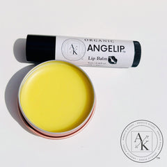 Lip balm with yellow balm in a tin, black tube, and "ANGELIP" text on white label