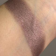 Close-up of shimmering Maiden Eyeshadow palette showing rich pigmented powder textures in warm bronze and copper tones