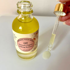 Makeup remover bottle with yellow liquid, clear glass, and gold dropper cap, "OFF" label visible