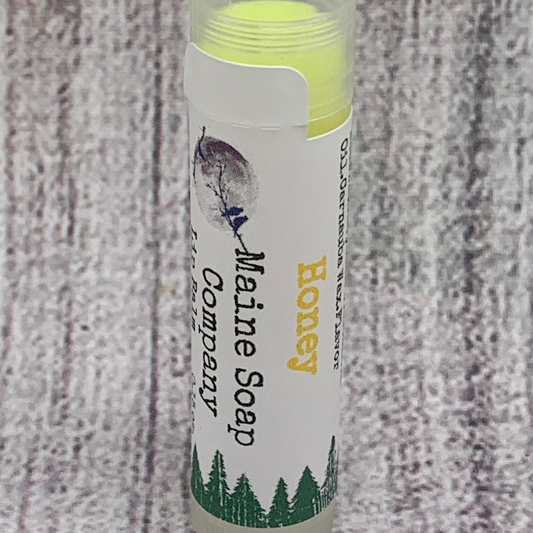Honey lip balm with yellow balm, white label, and Maine Soap Company text