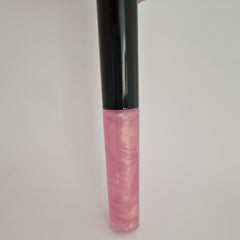 Lip gloss tube with black cap, pink and gold shimmer, for lip application