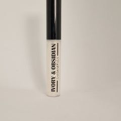 Lip gloss tube with black cap, clear gloss, and Ivory & Obsidian text