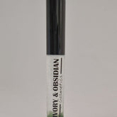 Lip gloss tube with black cap, clear body, and Ivory & Obsidian Cosmetics text