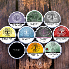Skin Care Salve tins with Woodland Herbal logo, various colors, round metal containers