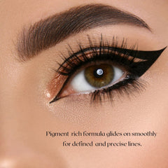 Eyeliner wing, black liquid, defined shape, applied to eye for precise lines