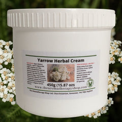 Elegant hand applying yarrow herbal cream onto glowing skin with gentle upward strokes