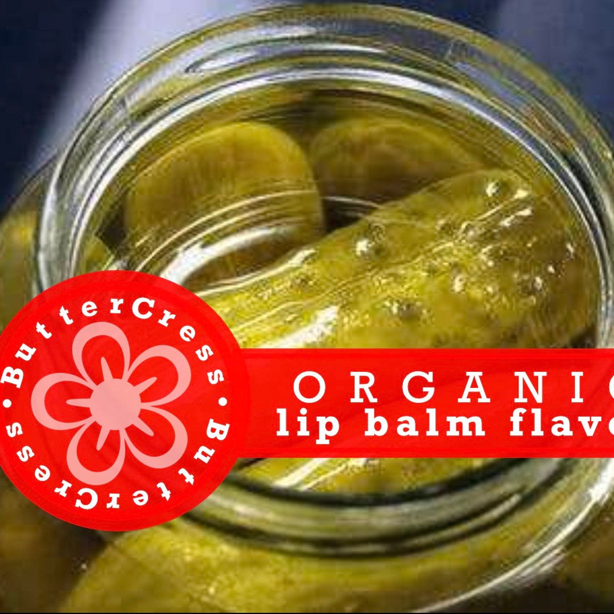 Lip balm flavor oil with green pickles in a glass jar, red banner with Butter Cress text
