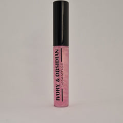 Lip gloss tube with black cap, pink iridescent gloss, and Ivory & Obsidian Cosmetics text