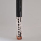 Lip gloss tube with clear liquid, black cap, and Ivory & Obsidian Cosmetics text