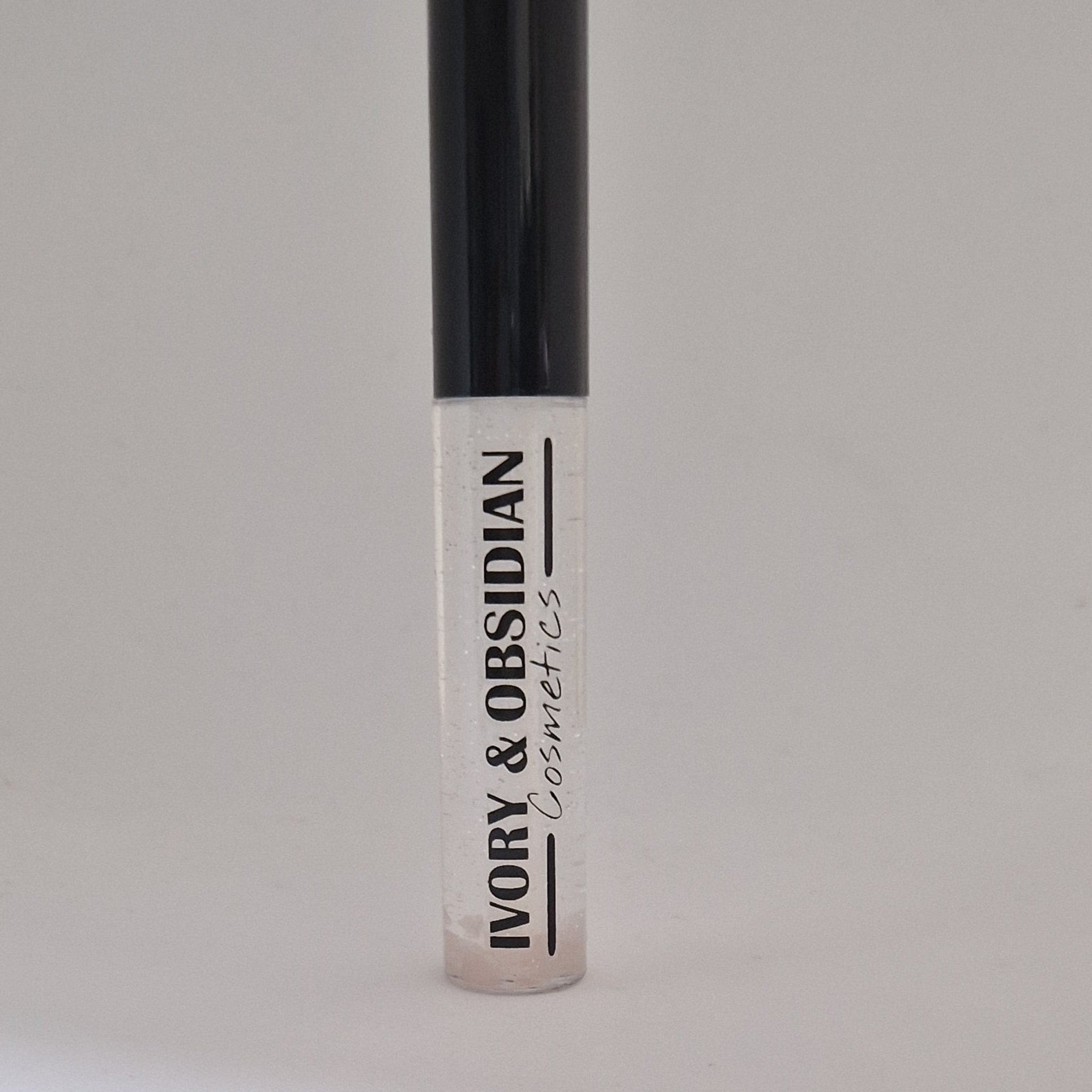 Lip gloss tube with clear gloss, black cap, and Ivory & Obsidian text