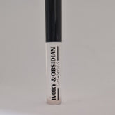 Lip gloss tube with clear gloss, black cap, and Ivory & Obsidian text