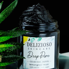 Close-up of rich black charcoal balm in sleek jar with gold lid, showcasing velvety texture for deep pore cleansing