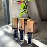 Eye makeup Lid Glitz, three gold-capped bottles with black text, clear tubes filled with dark blue glitter liquid