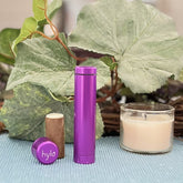 Lip balm, purple aluminum tube and cap with Hylo logo, with lip balm stick and candle