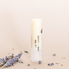 Lip balm tube, white with black text, honeycomb pattern, HandCraft Skincare branding visible