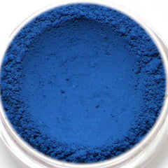 Blue powder in a clear container with a textured surface and a smooth center