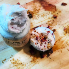 Goat milk cleanser with white and pink cream, rose petals, and visible Goat Creek Soap Co. label
