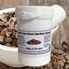 Close-up of creamy wild yam root treatment in minimalist white jar with herbal details