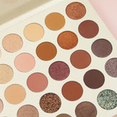 Open Startle Eyeshadow Palette displaying 35 vibrant matte and shimmer color pans in a sleek black case
