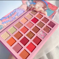 Side view of 24-color eyeshadow palette showing matte and glitter shades in rectangular pans with cartoon-themed packaging