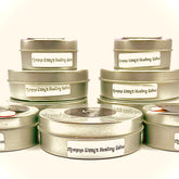 Healing salve in silver metal tins with white labels, Momma Sissy's Healing Salve text visible