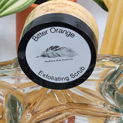 Exfoliating scrub jar with black lid, white label, and "Bitter Orange" text, Medicine Man Medicine brand