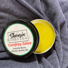 Comfrey salve, yellow balm in metal tin, The Shearin Homestead label on black lid
