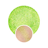 Vegan eyeshadow with green shimmer and golden glitter, swatched on skin
