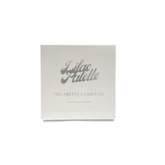 Close-up of lilac eyeshadow palette showing smooth matte and shimmer shades with finger swatches